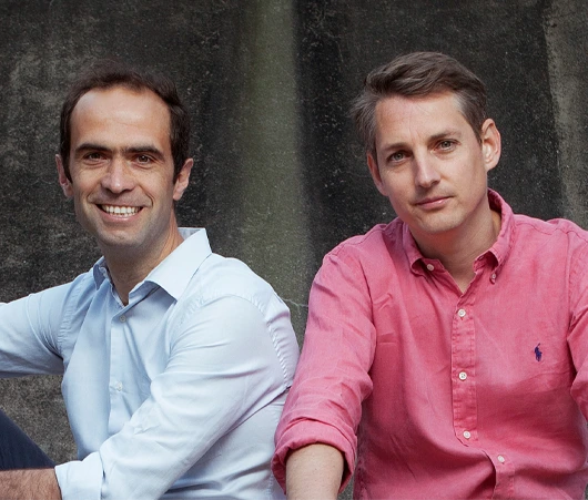 Co-founders of Famileo, Tanguy de Gélis and Armel de Lesquen, standing together and smiling.